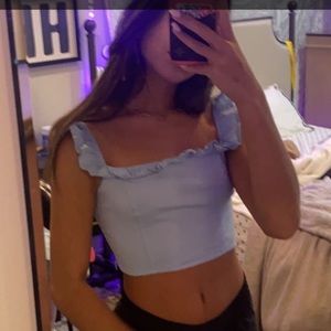Blue top with ruffles along the top